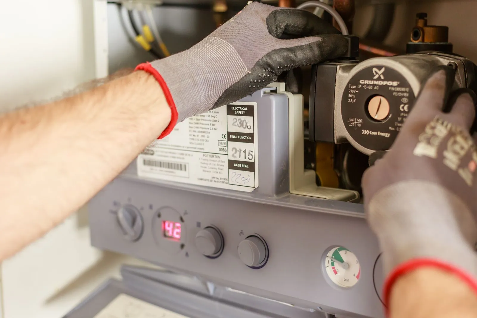 Plumber servicing mechanical equipment