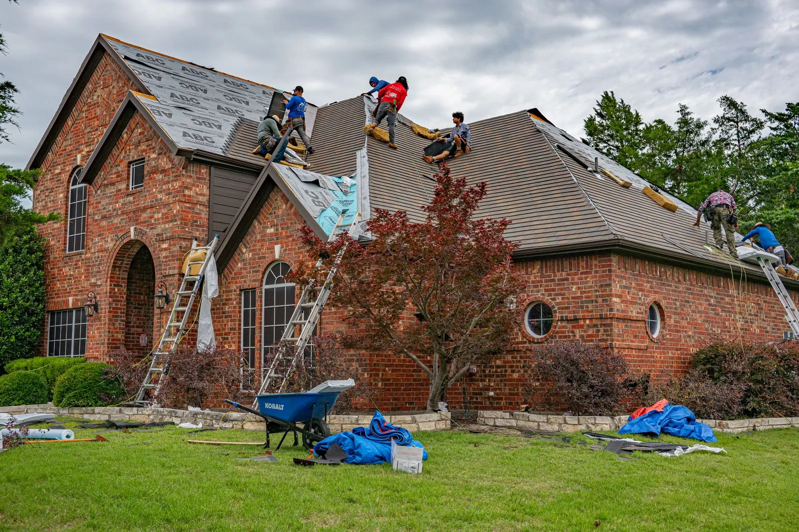 Roofing crew working on a residential property